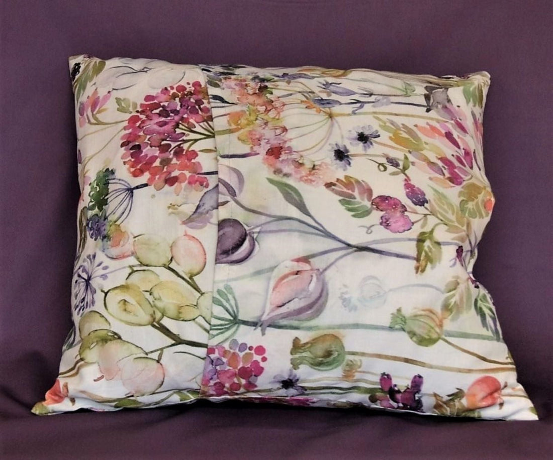 An envelope cushion in floral fabric showing the rear side with envelope flap