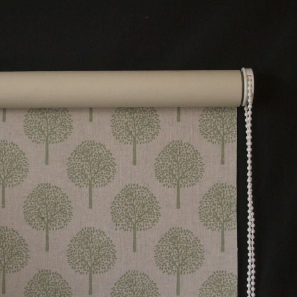 Detail of a roller blind made with tree design fabric and roller blind backing and showing a white chain mechanism