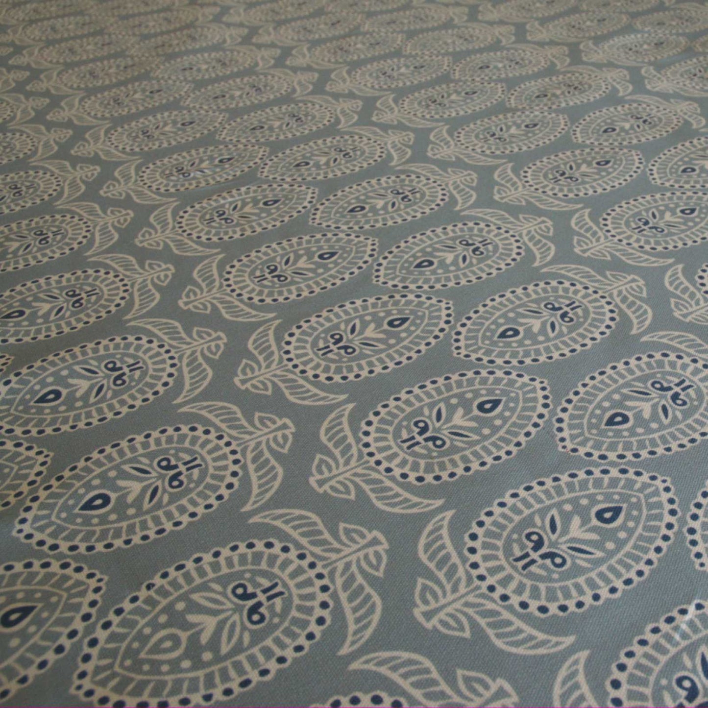 Curtain fabric with block print design on duck egg blue background