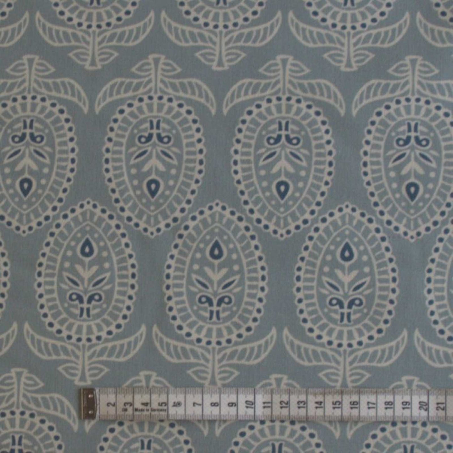 Curtain fabric in duck egg with rule to show size of block print design