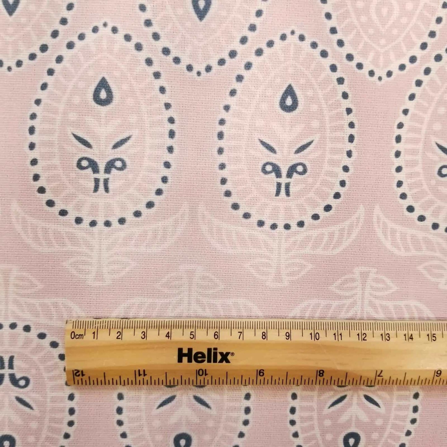 Curtain fabric in Pale pink with rule to show size of block print design