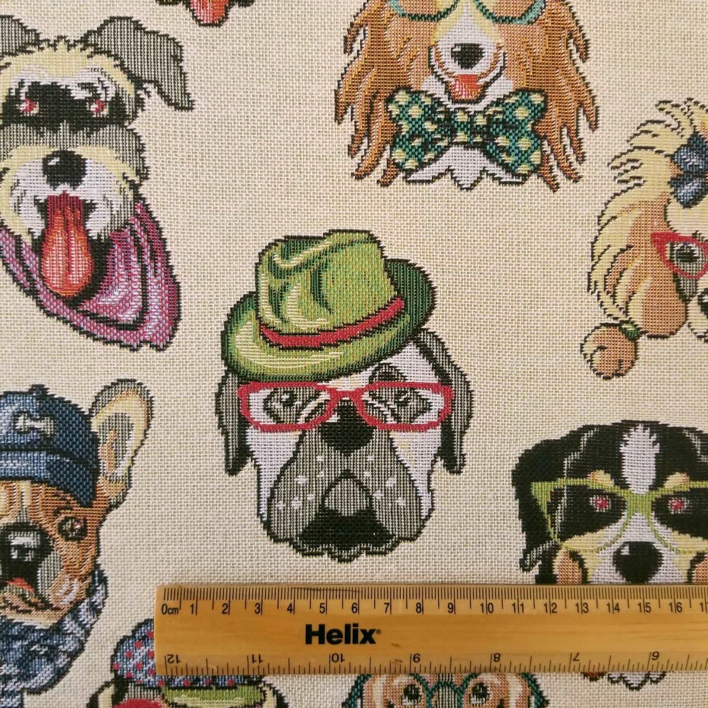 Tapestry fabric with a design of cartoon dogs and a rule for scale