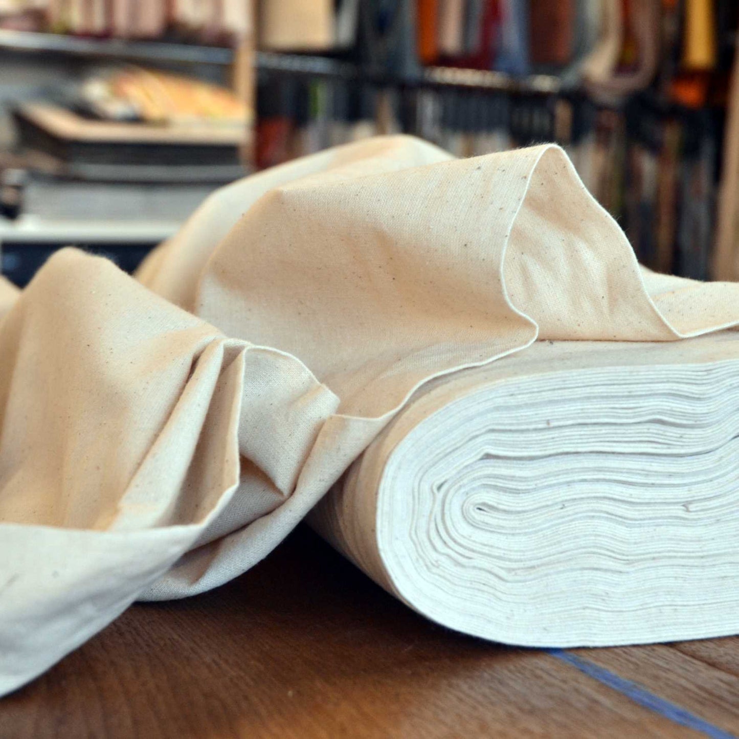 A roll of heavyweight natural undyed calico fabric