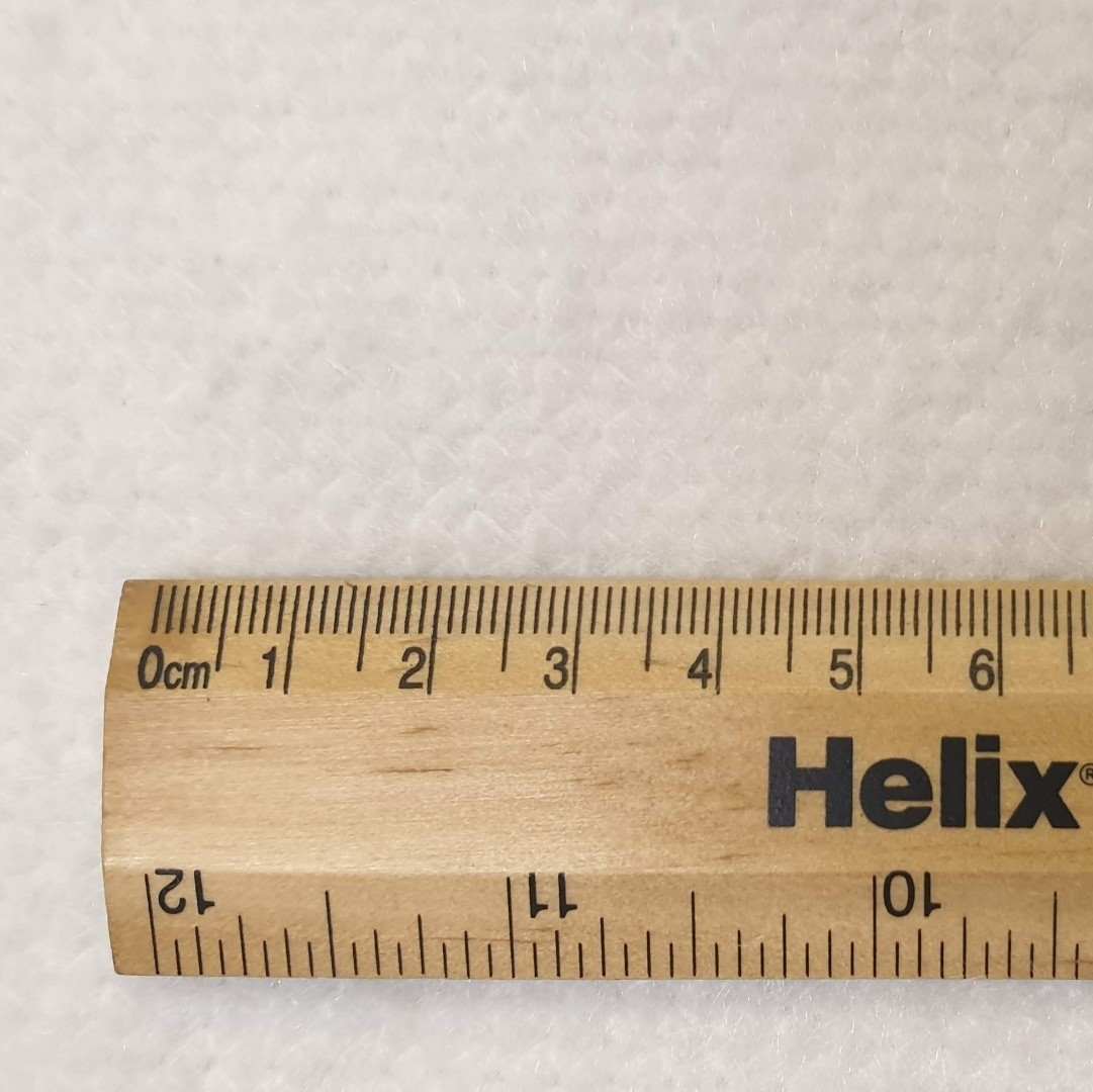Synthetic curtain bump cream heavyweight with a rule for scale