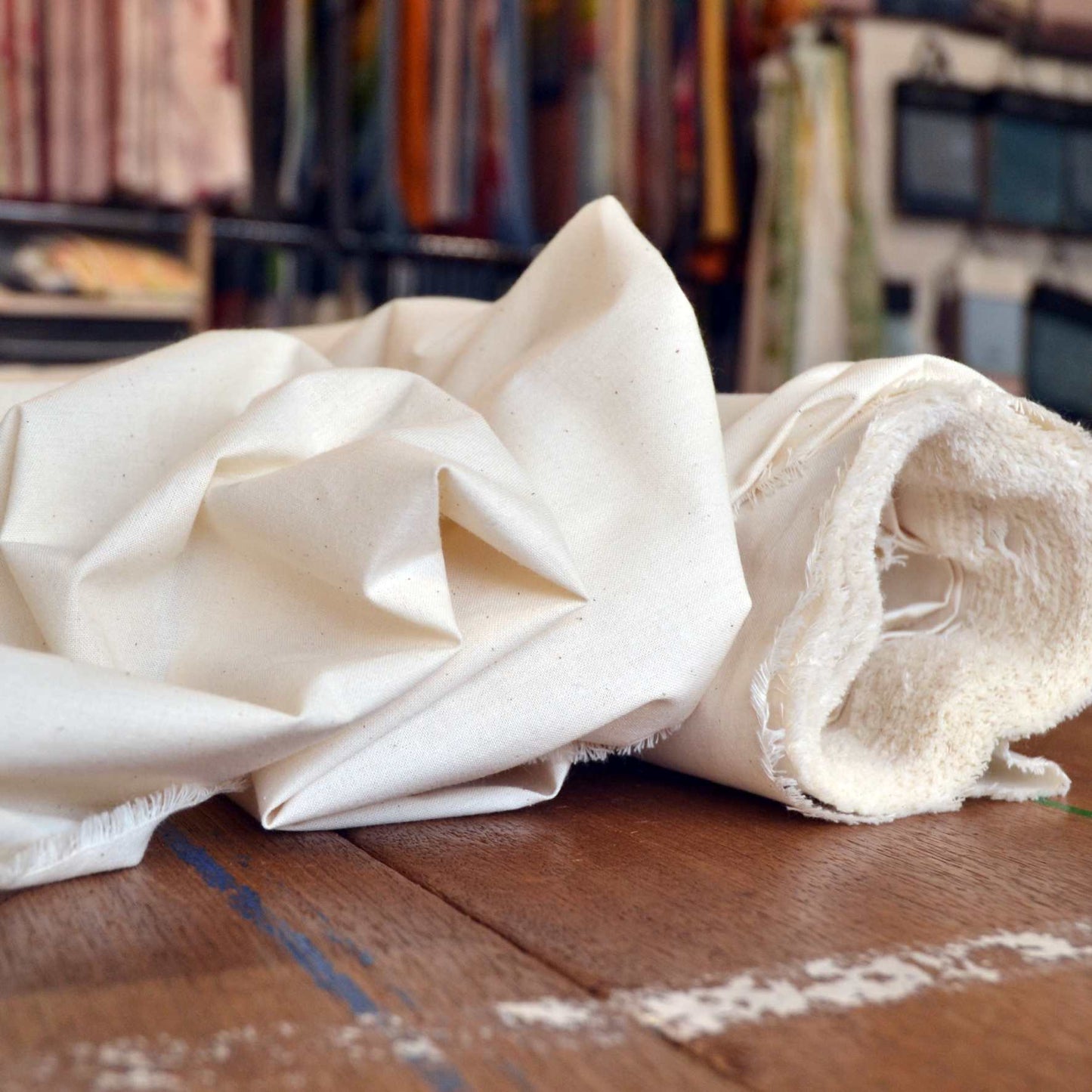 A roll of medium weight natural undyed calico fabric