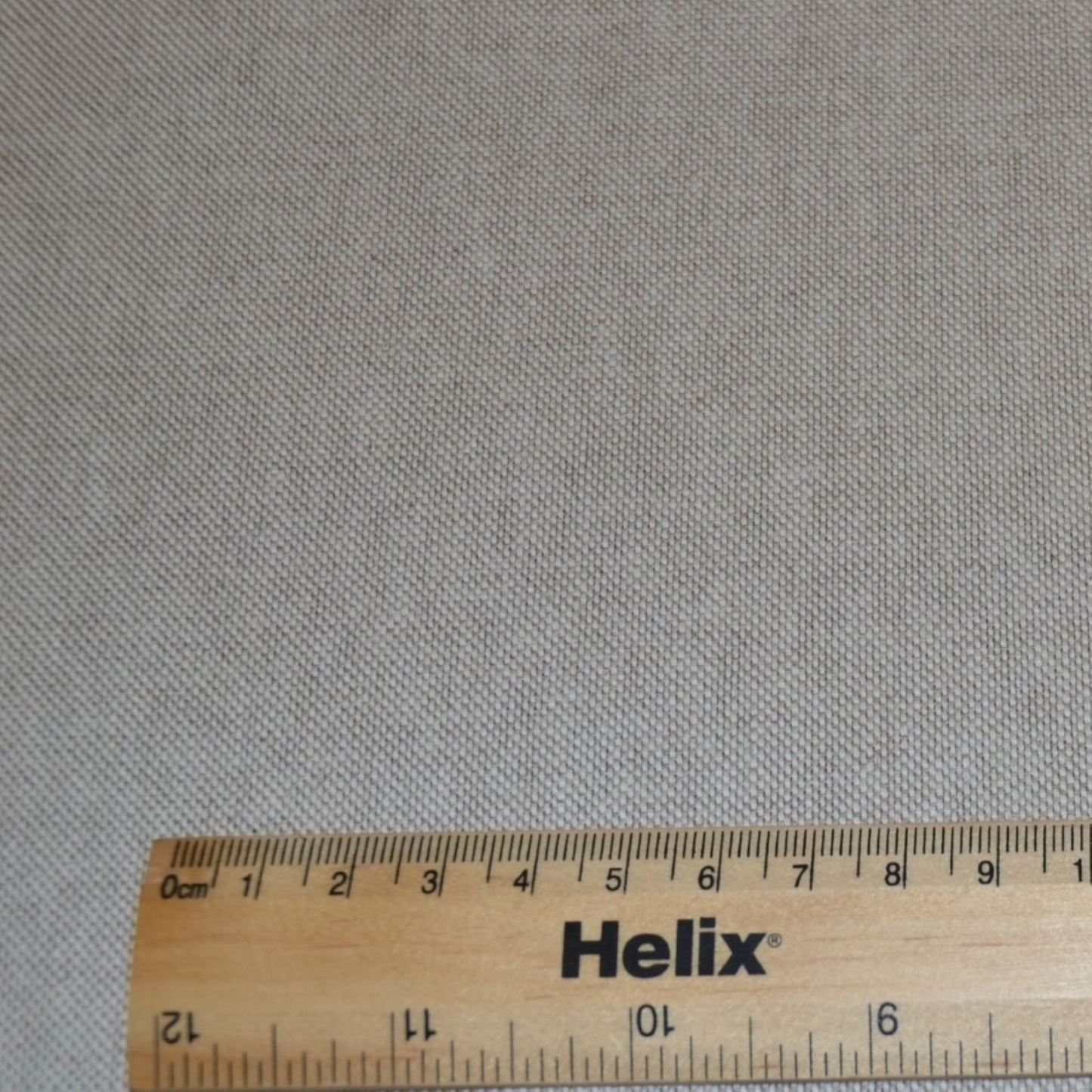 A plain linen look fabric with a rule for scale
