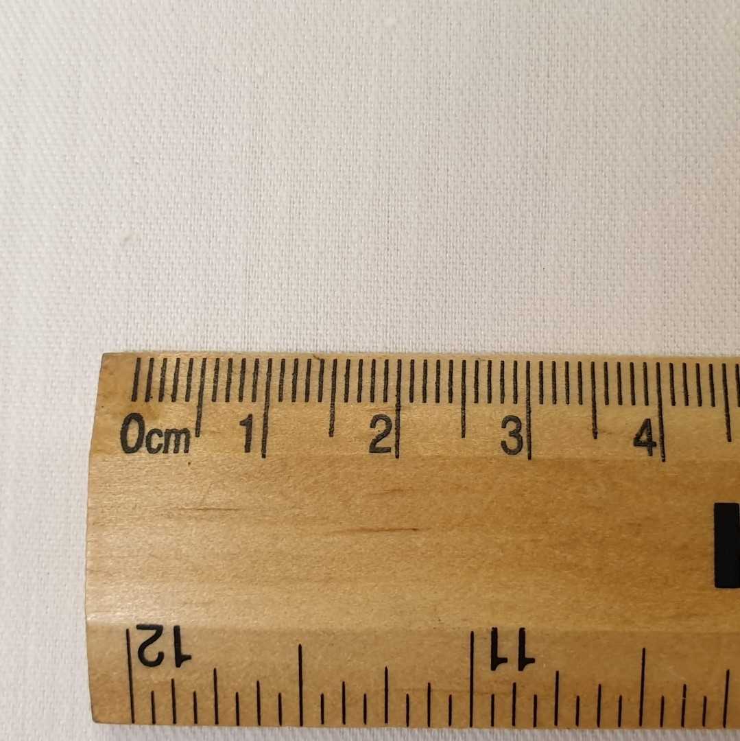 Ivory polycotton curtain lining with a rule for scale