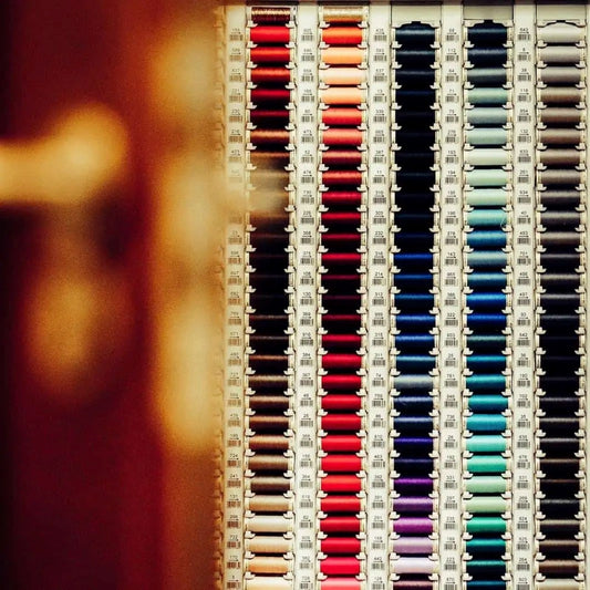 A stand of sewing thread in various colours