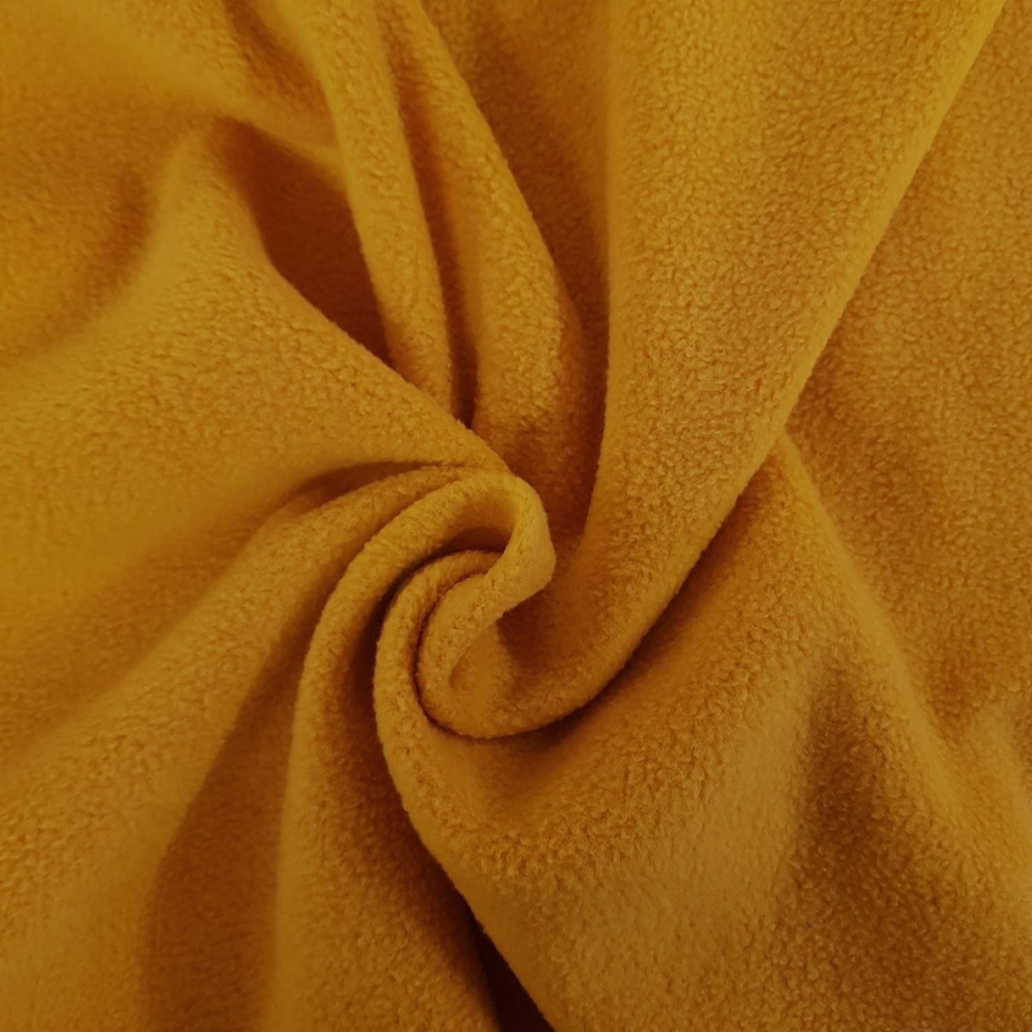 Mustard colour fleece fabric in a swirl available online