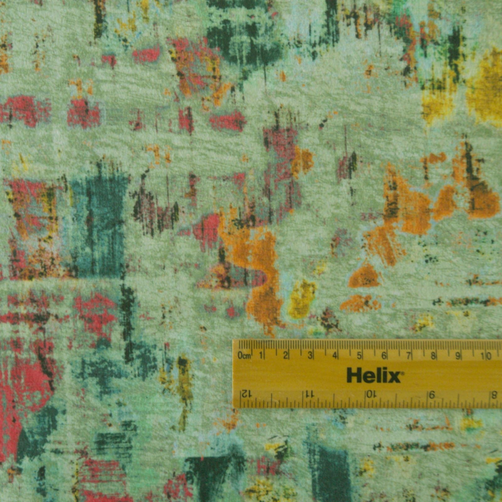 Blue velvet fabric with a rule showing scale of abstract brushstrokes design