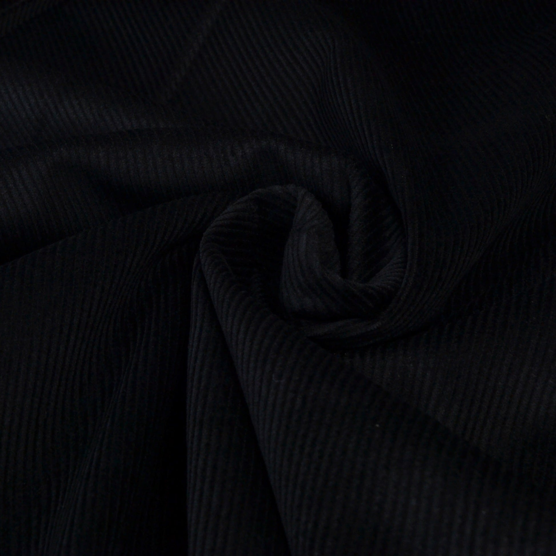 Black corduroy ribbed fabric for dressmaking or upholstery