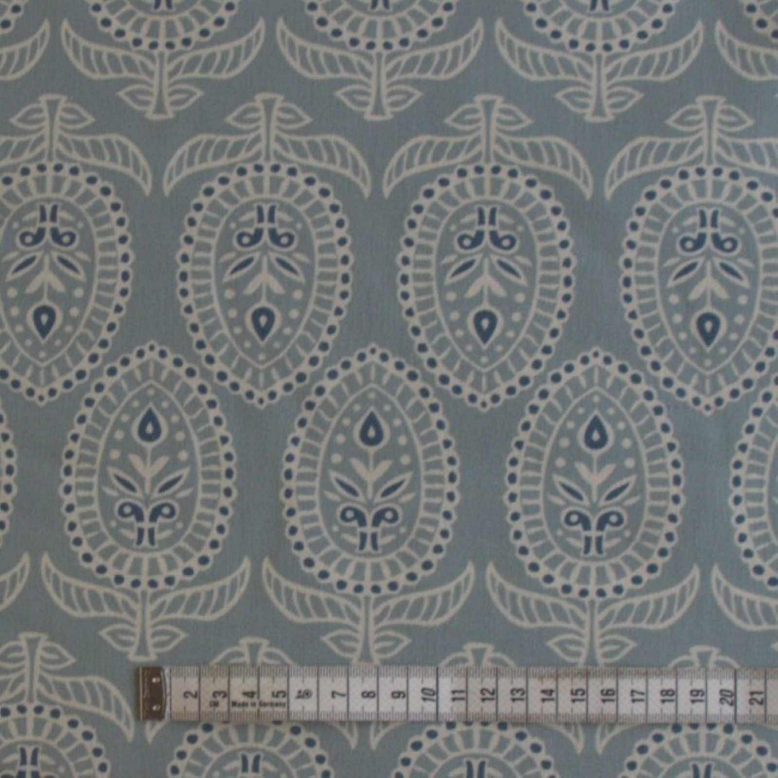 Curtain fabric in duck egg with rule to show size of block print design