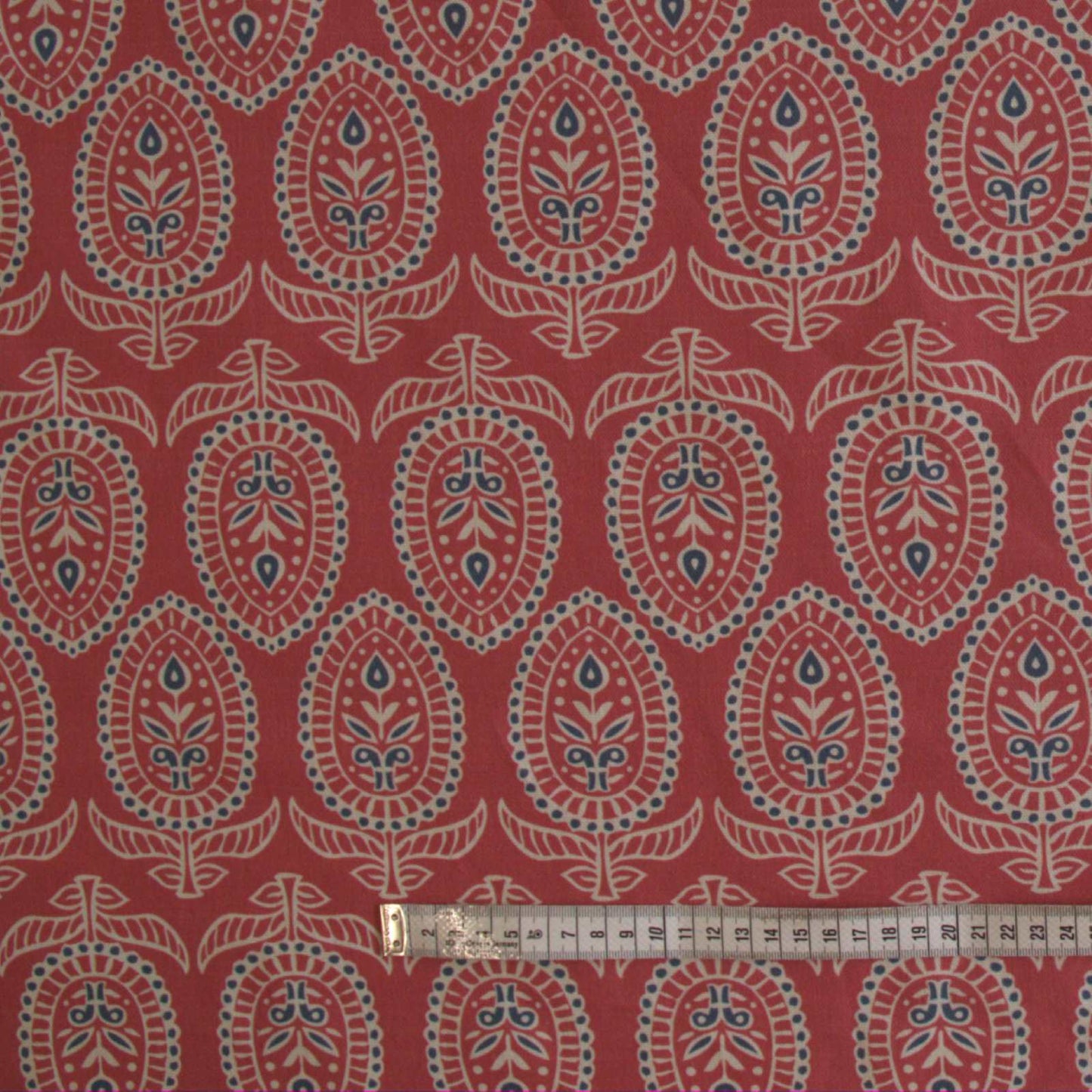 Curtain fabric in red with rule to show size of block print design