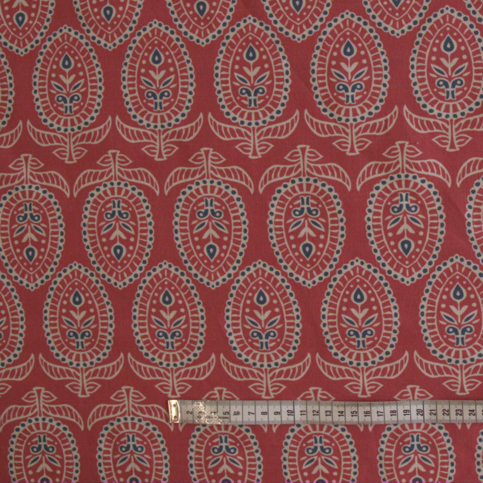 Curtain fabric in red with rule to show size of block print design