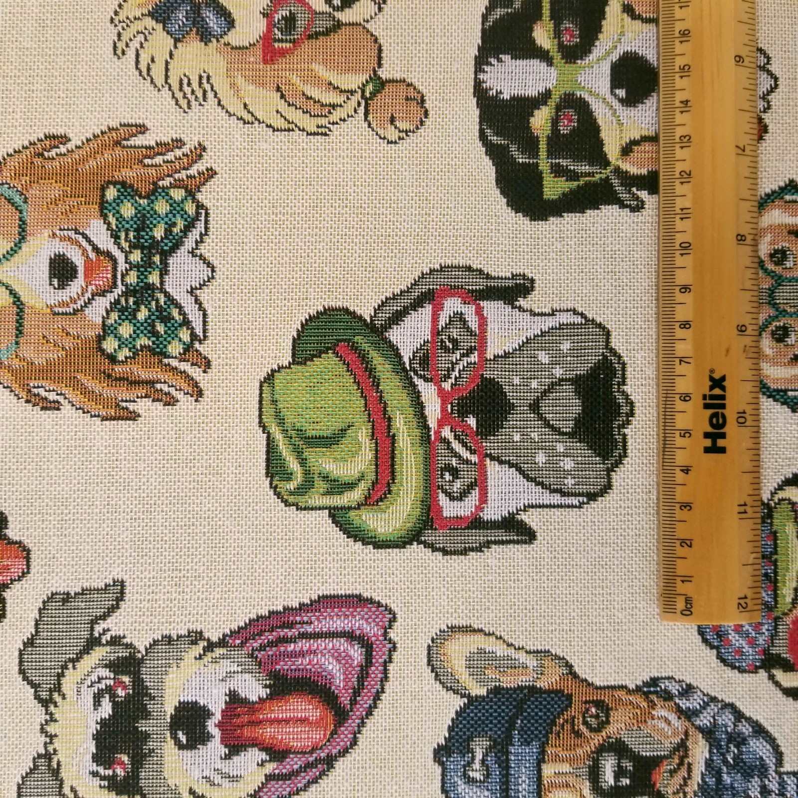 Tapestry fabric with a design of cartoon dogs and a rule for scale