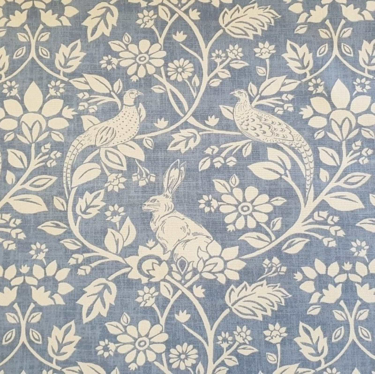 Hares and Pheasants design printed curtain fabric with a blue background and cream design