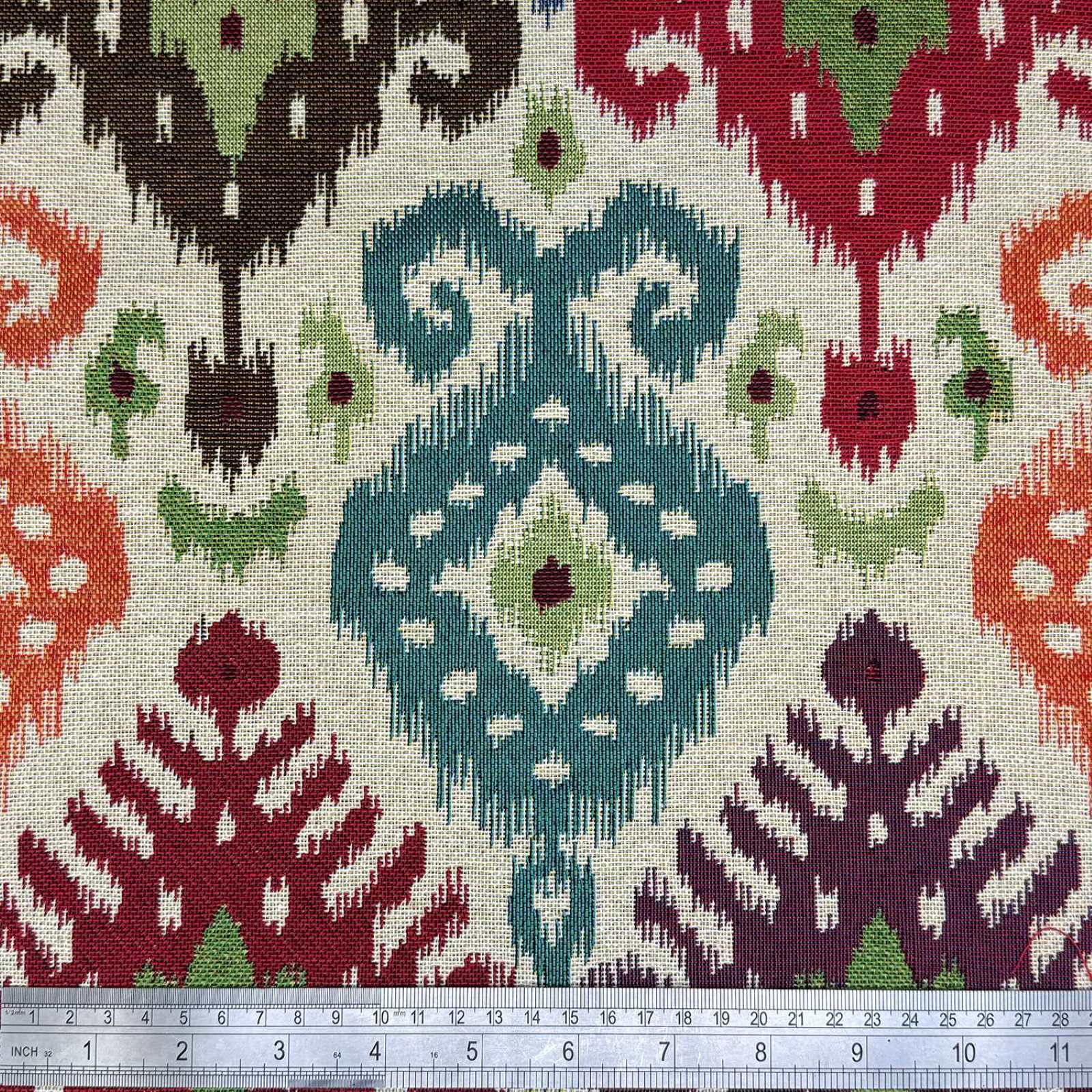 Tapestry fabric with a multicolour Ikat design and a rule for scale