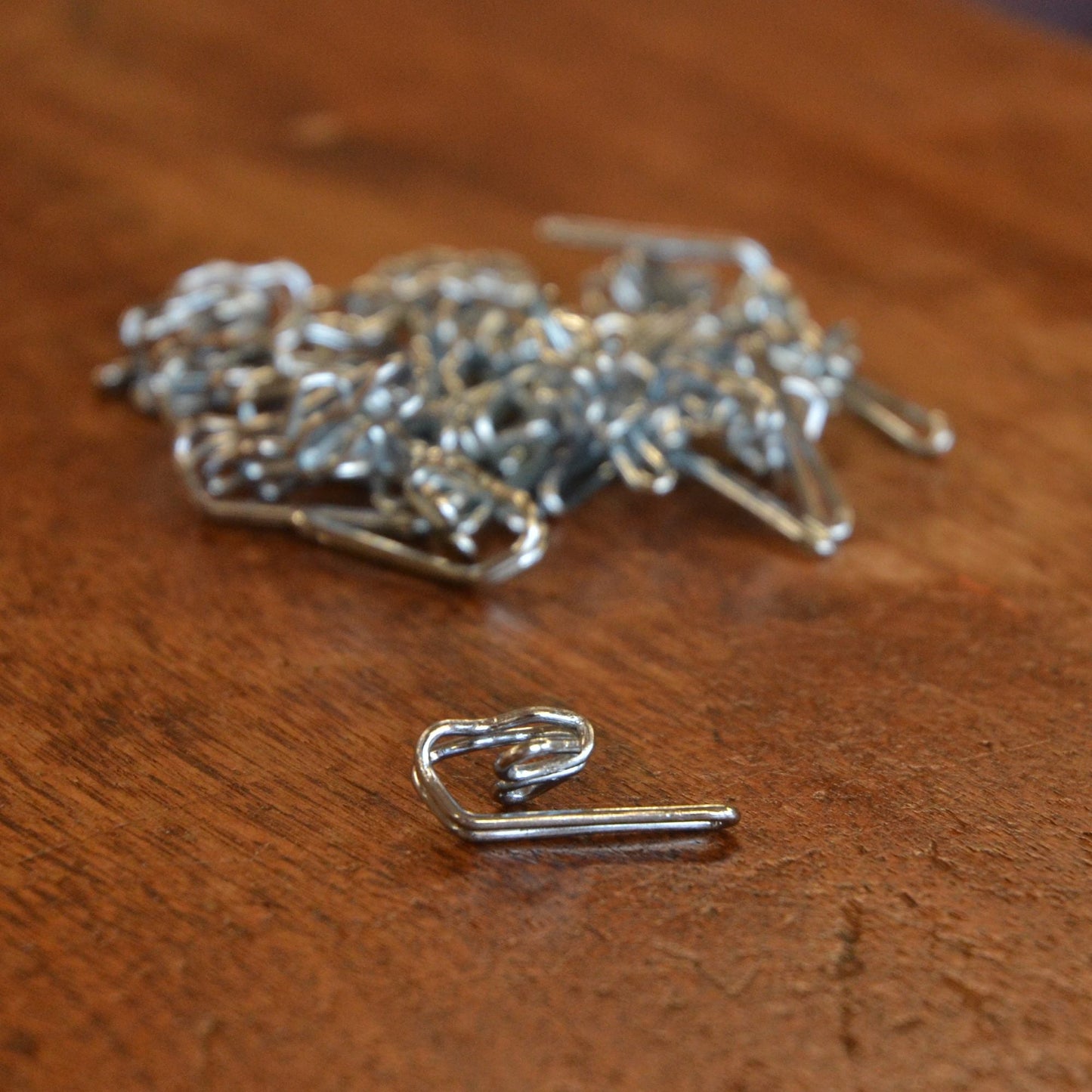Metal curtain hooks available to buy online silver colour on a table
