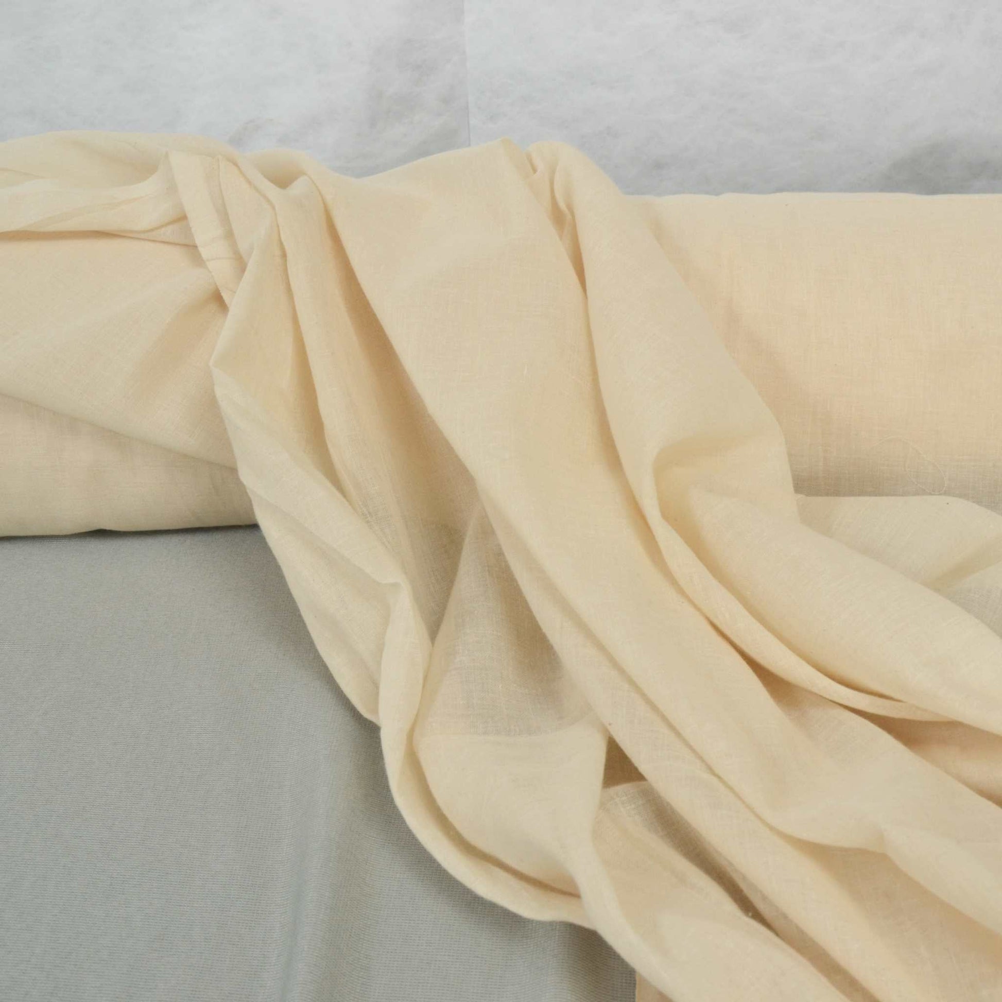 A roll of natural unbleached muslin fabric