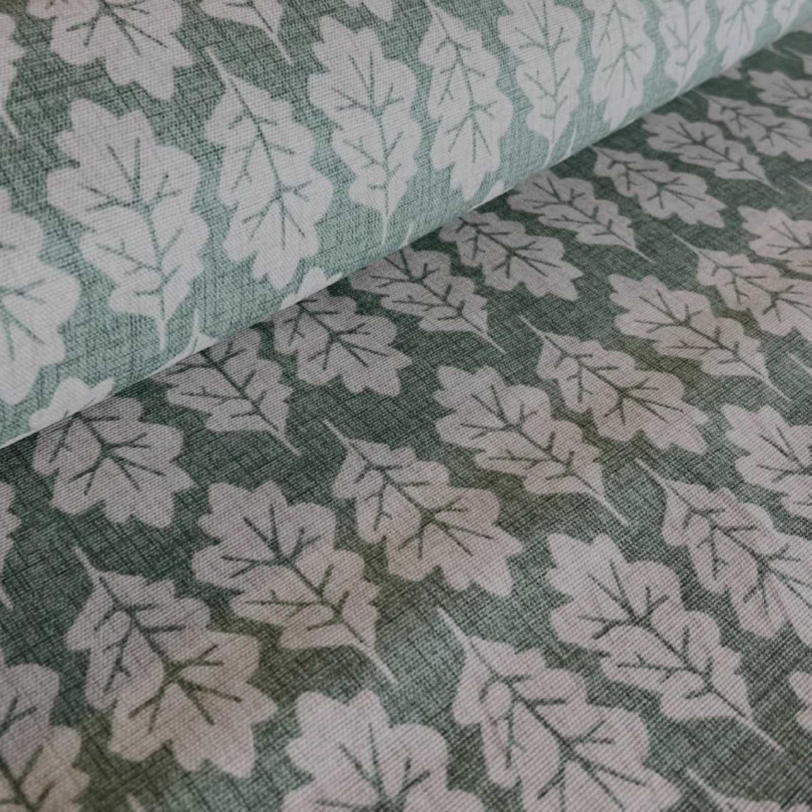 A roll of cotton curtain fabric with oak leaf print in green