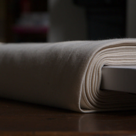 A roll of natural seeded unbleached osnaburg fabric