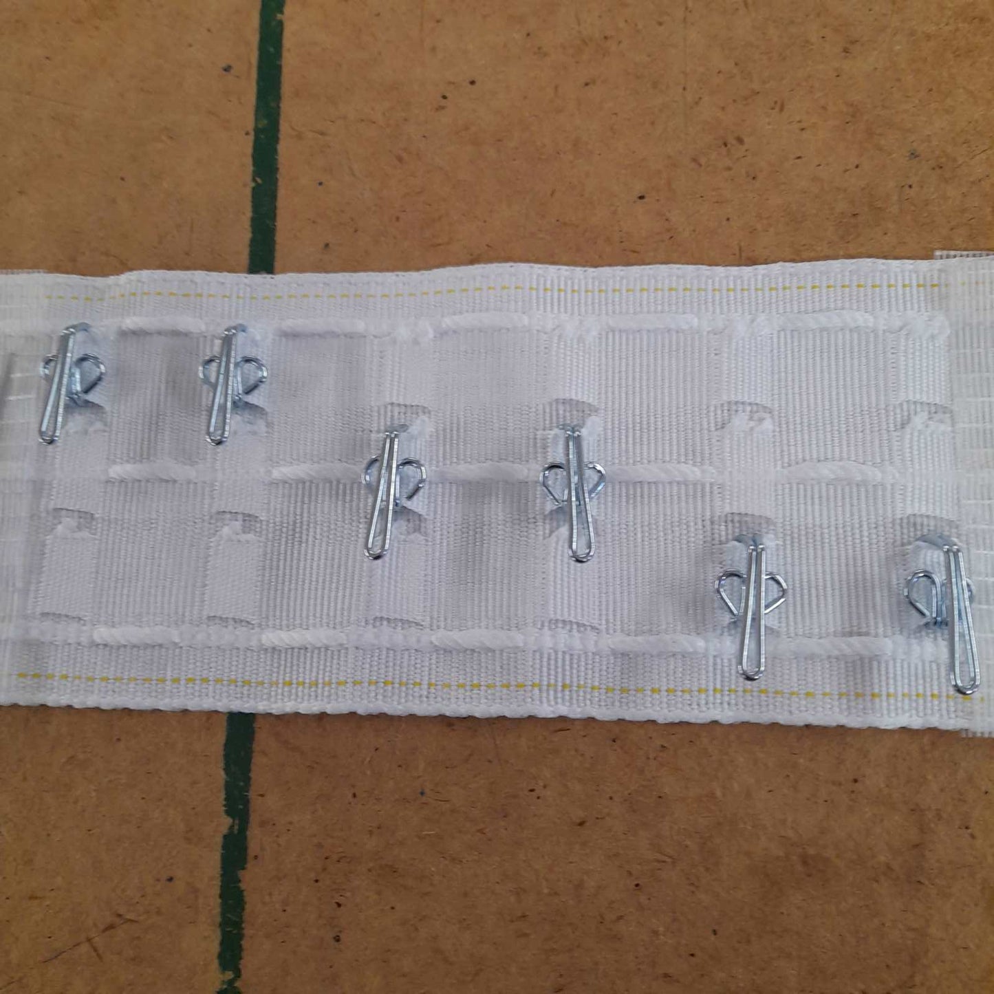 Standard size pencil pleat header tape with 3 hook positions shown with metal hooks