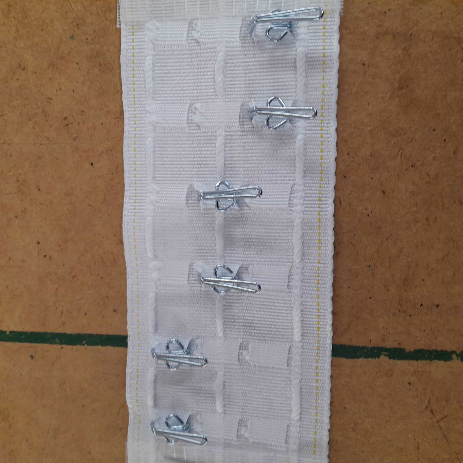 Standard size pencil pleat header tape with 3 hook positions shown with metal hooks