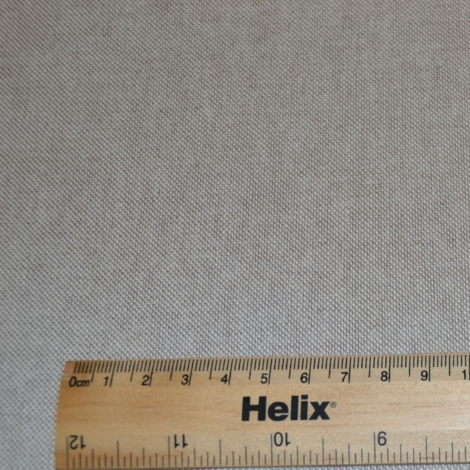 A plain linen look fabric with a rule for scale