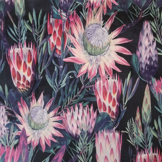 Printed Velvet with a large pink Protea flower pattern on a black background