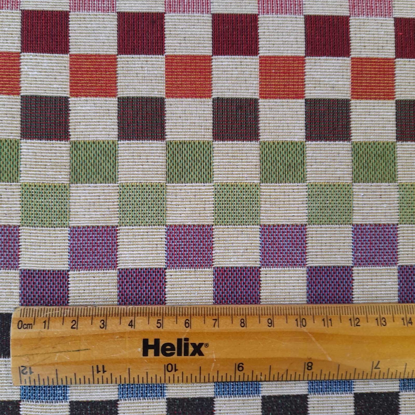 Tapestry upholstery or curtain fabric with a rule for scale of raindow squares design