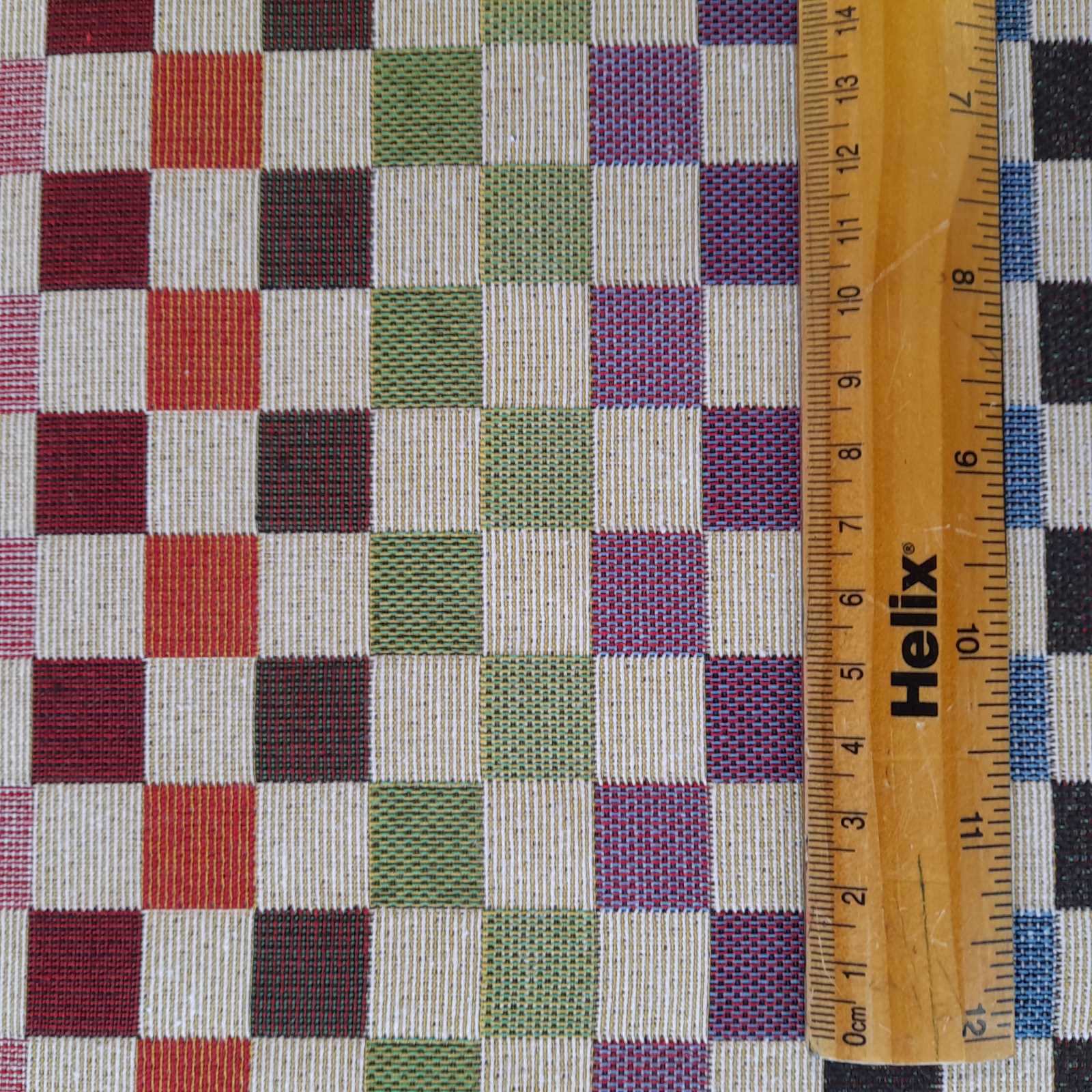 Tapestry upholstery or curtain fabric with a rule for scale of raindow squares design