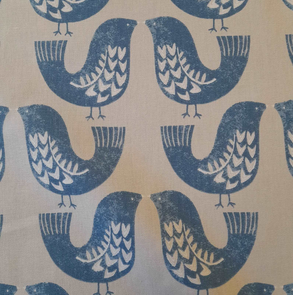 Curtain fabric with a scandi bird design in turquoise