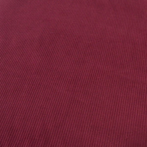 Wine Red Cotton 8 wale corduroy fabric photographed at an angle
