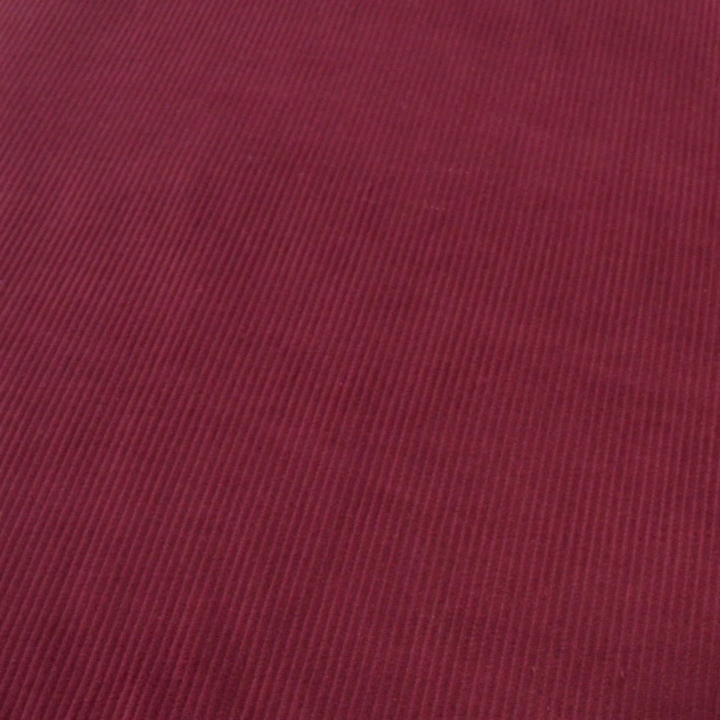 Wine Red Cotton 8 wale corduroy fabric photographed at an angle