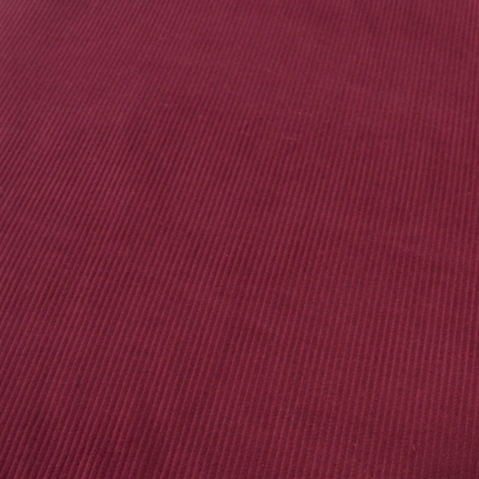 Wine Red Cotton 8 wale corduroy fabric photographed at an angle
