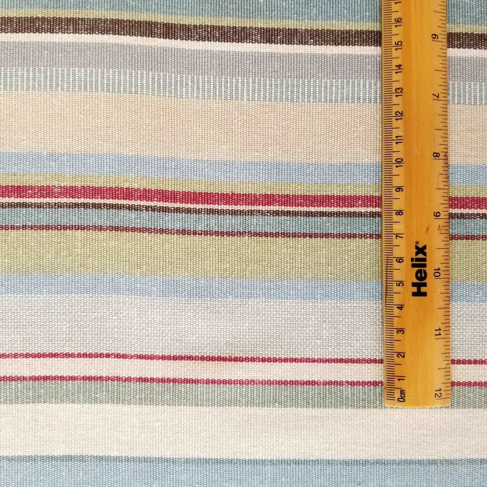 Cotton fabric with a rule showing scale of woven blue green stripe design