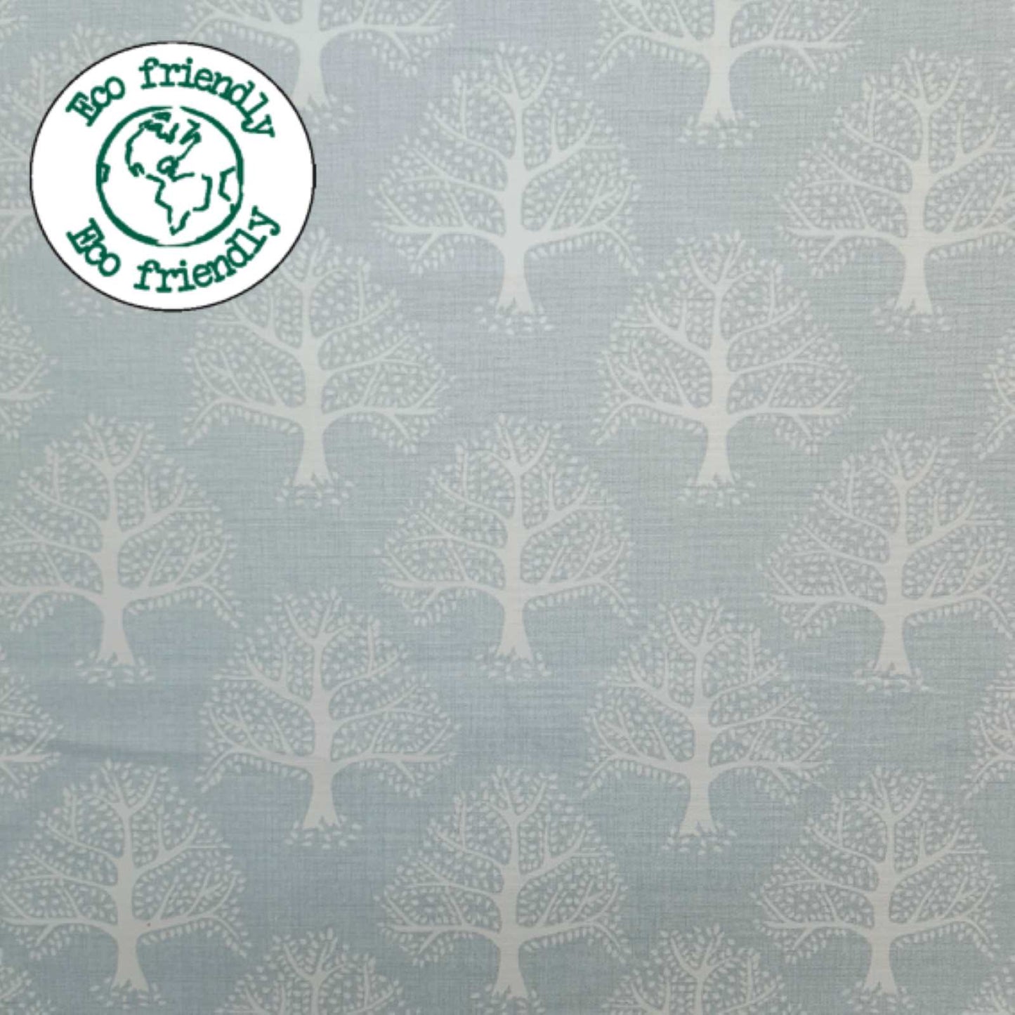Light Blue Fabric with a print of oak trees and and eco friendly badge
