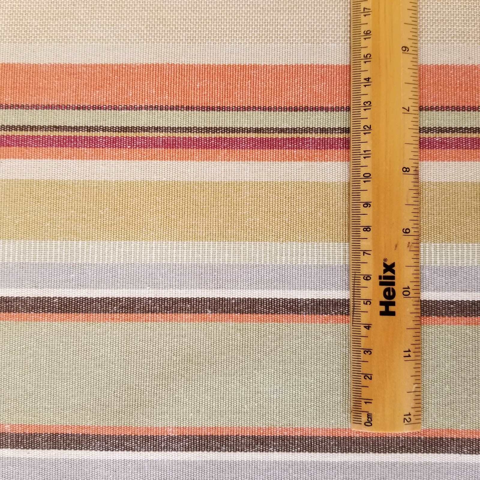 Cotton fabric with a rule showing scale of woven terracotta stripe design